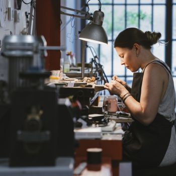 A jeweler woman working at her bench