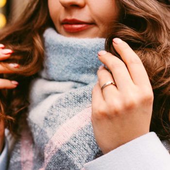 Woman wearing a white and blue scarf