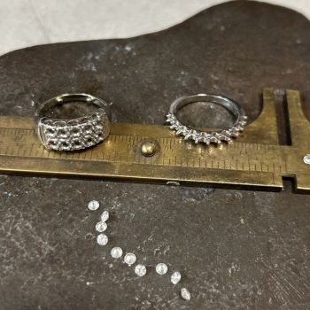 Two rings on a bench jeweler table